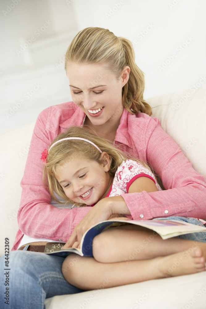 Mother And Daughter Reading Book In Bedroom Mother And Daughter Reading Book In Bedroom
