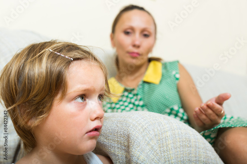 Crying child and mother having quarrel