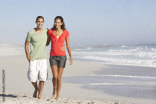 Young Couple Walking Along Beach