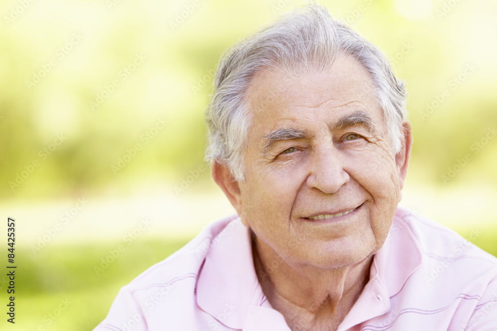 Senior Hispanic Man Relaxing In Park Senior Hispanic Man Relaxing In Park