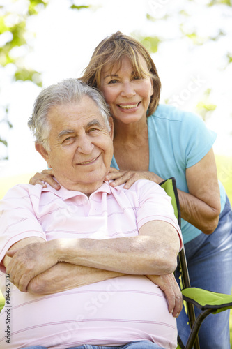 Senior Hispanic Couple Relaxing In Park