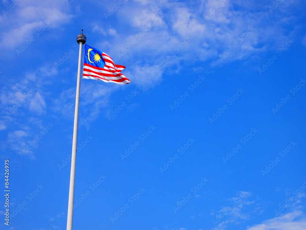 Malaysia flag waving on the wind with blue sky Malaysia flag waving on the wind with blue sky