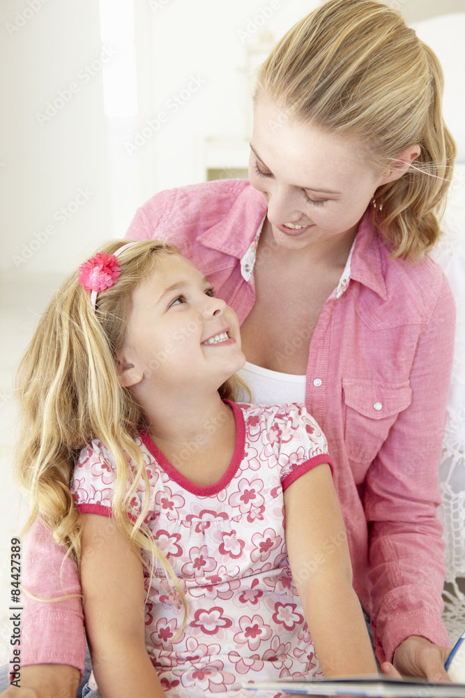 Mother And Daughter Reading Book In Bedroom Mother And Daughter Reading Book In Bedroom