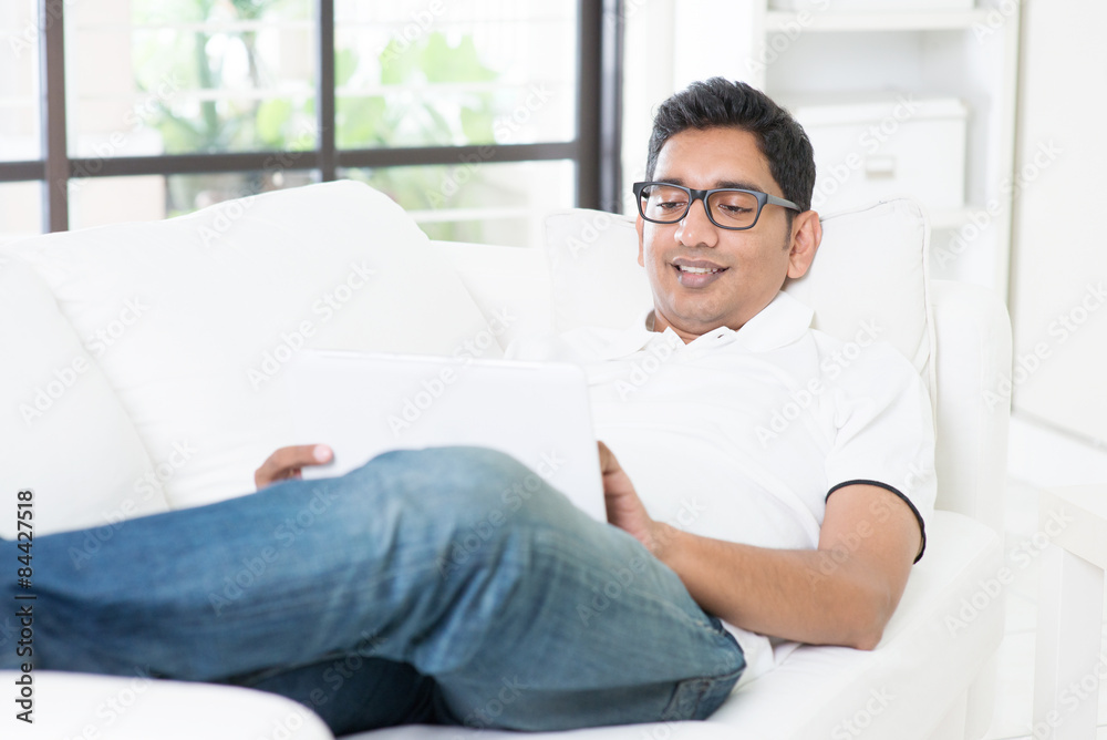 Indian guy using digital computer tablet Indian guy using digital computer tablet