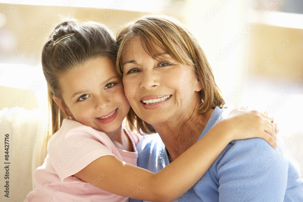 Hispanic Grandmother And Granddaughter Relaxing At Home Hispanic Grandmother And Granddaughter Relaxing At Home