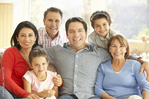 Portrait Of Extended Hispanic Family Relaxing At Home