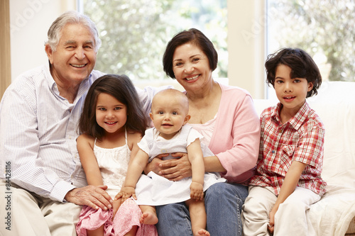 Hispanic grandparents at home with grandchildren