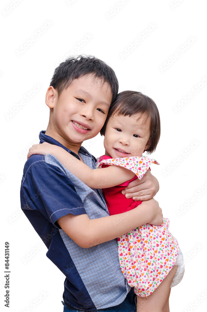 Young Asian brother holding his sister over white background Young Asian brother holding his sister over white background