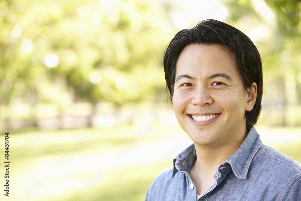 Head and shoulders portrait Asian man outdoors Head and shoulders portrait Asian man outdoors