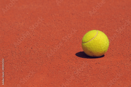 Tennis ball on a clay court. © astrosystem