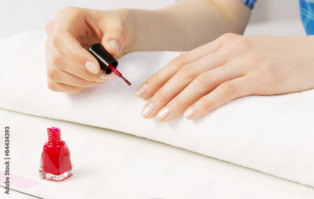 Woman applying polish Woman applying polish
