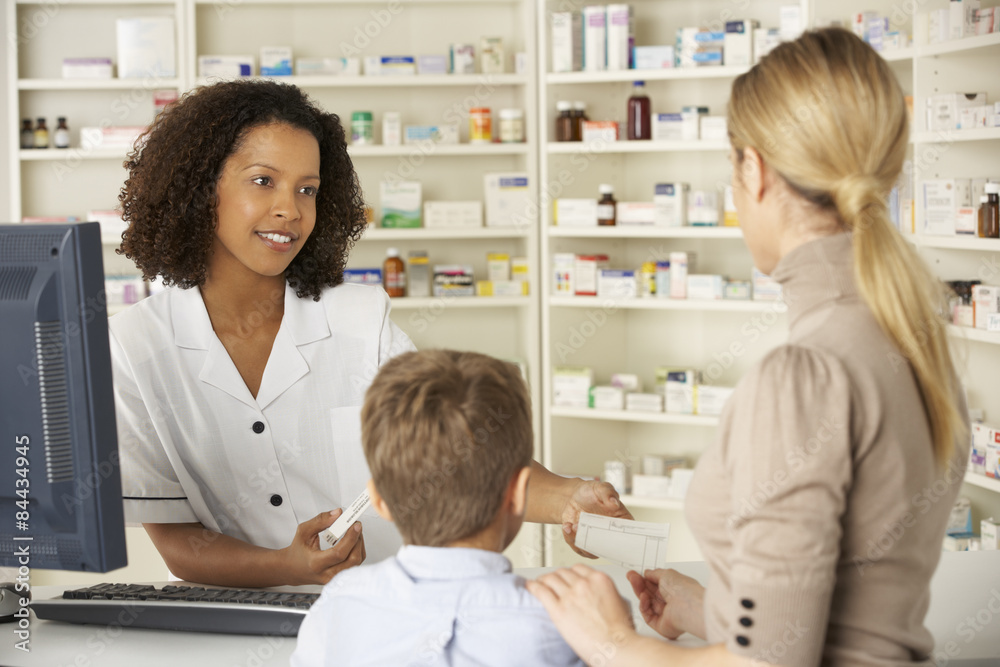 Pharmacist in pharmacy with mother and child Pharmacist in pharmacy with mother and child