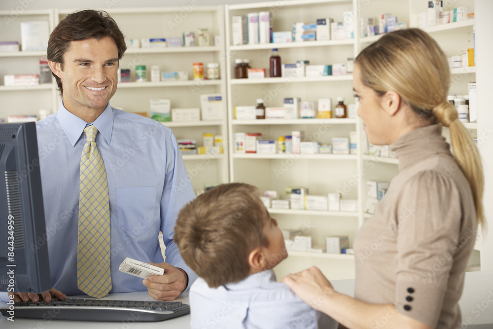 Pharmacist in pharmacy with mother and child Pharmacist in pharmacy with mother and child