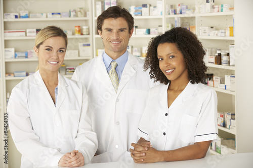 Nurse and pharmacists working in pharmacy photo