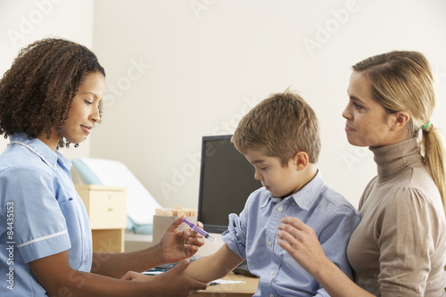 Nurse injecting child with mother