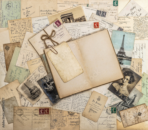 Open book, old letters and postcards. Travel memories scrapbook photo