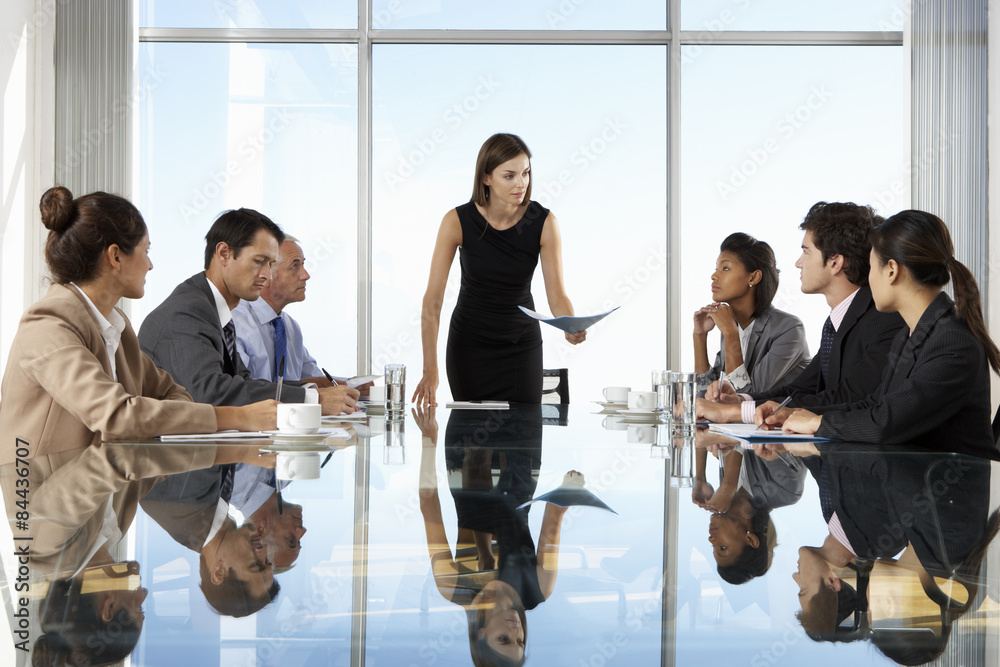 Group Of Business People Having Board Meeting Around Glass Table - obrazy, fototapety, plakaty 
