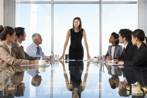 Group Of Business People Having Board Meeting Around Glass Table photo