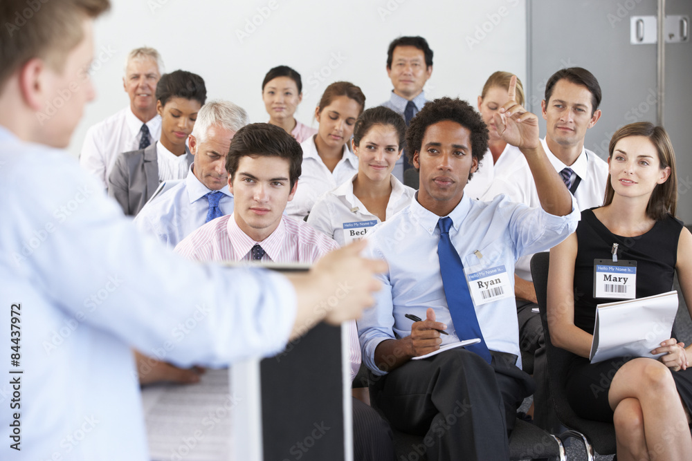 Businessman Delivering Presentation At Conference Businessman Delivering Presentation At Conference