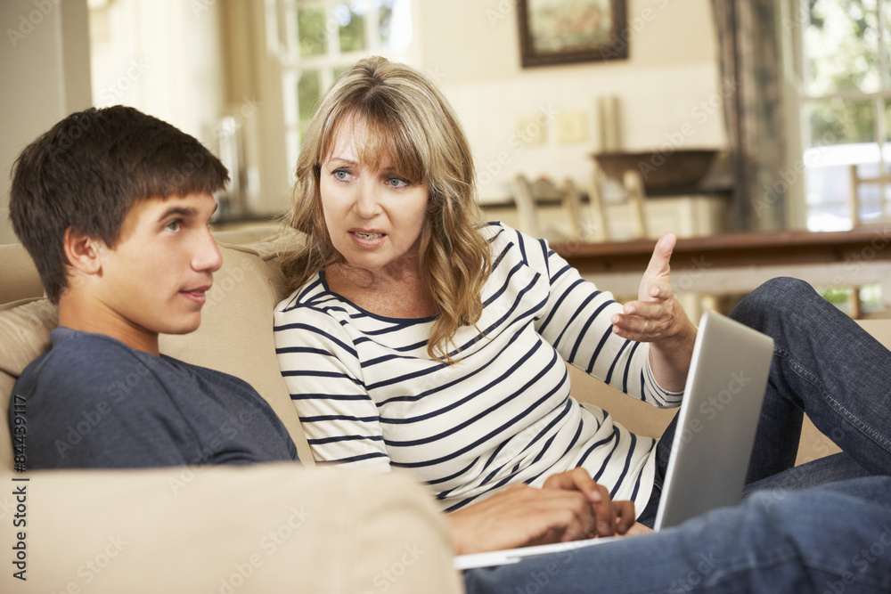 Mother And Teenage Son Arguing On Sofa At Home Mother And Teenage Son Arguing On Sofa At Home