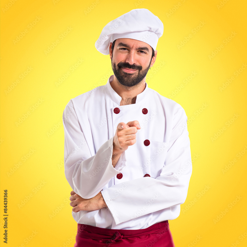 Chef pointing to the front over white background