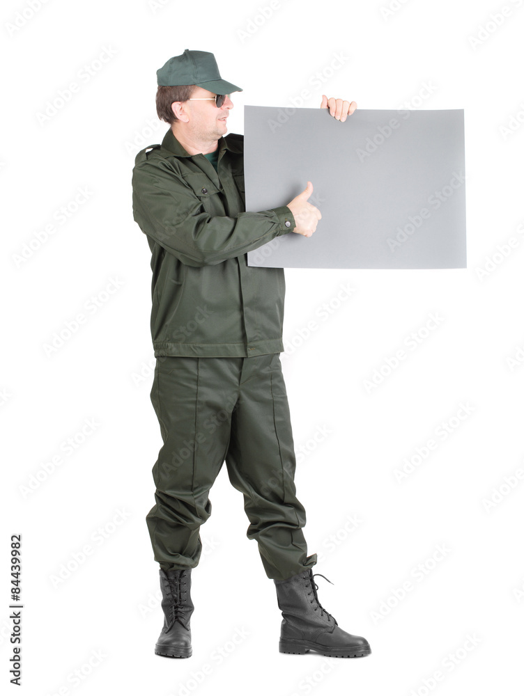 Man in workwear stands with paper. Man in workwear stands with paper.