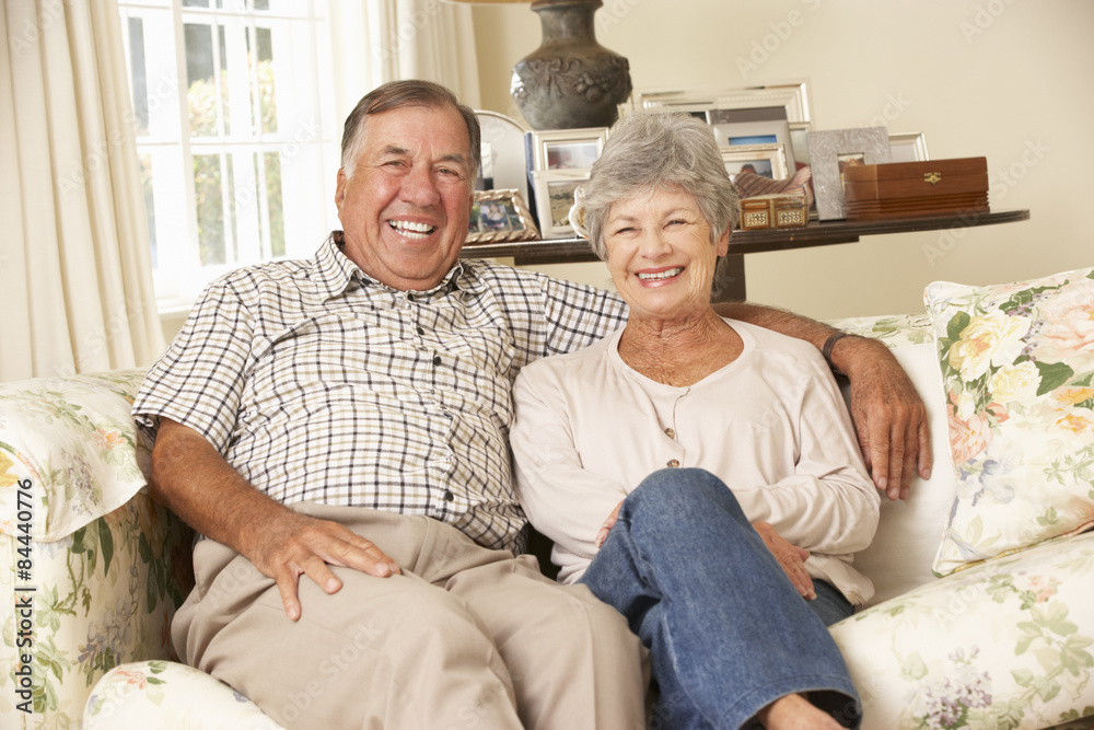 Retired Senior Couple Sitting On Sofa At Home Together Retired Senior Couple Sitting On Sofa At Home Together