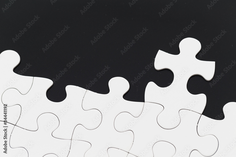 White puzzle over black background White puzzle over black background