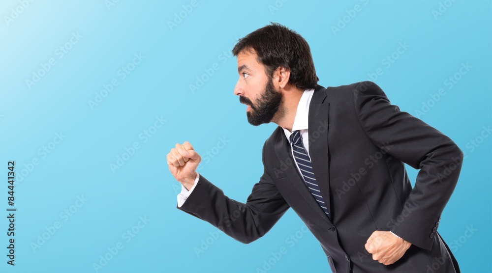 Businessman running fast over white background Businessman running fast over white background