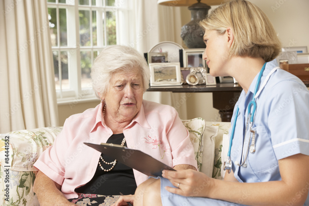 Obraz premium Retired Senior Woman Having Health Check With Nurse At Home