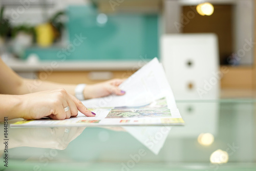 woman is reading magazine in the kitchen