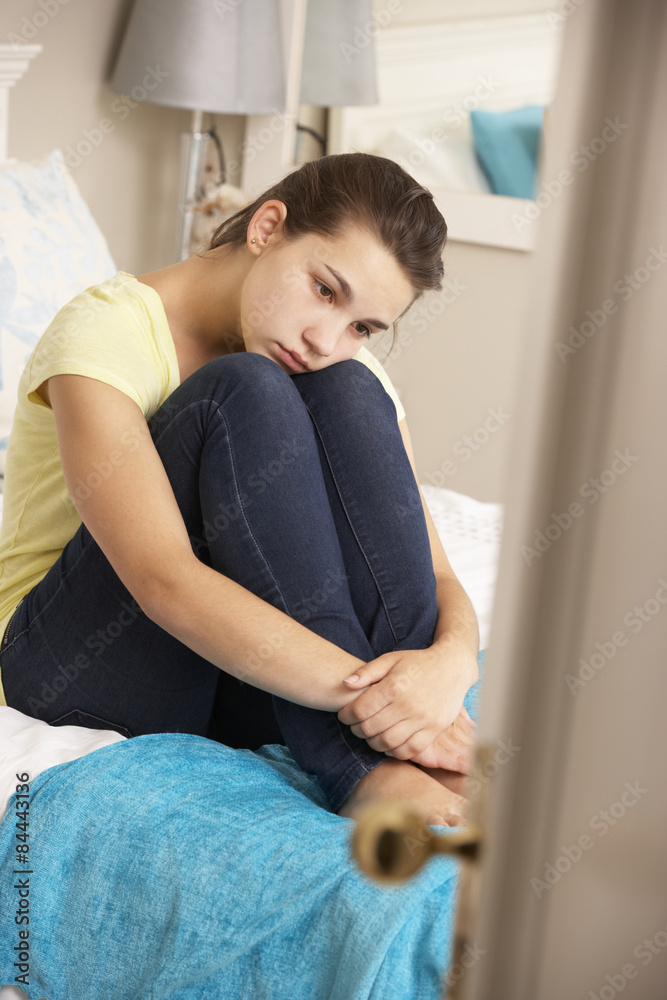 Depressed Teenage Girl Sitting On Bed Depressed Teenage Girl Sitting On Bed