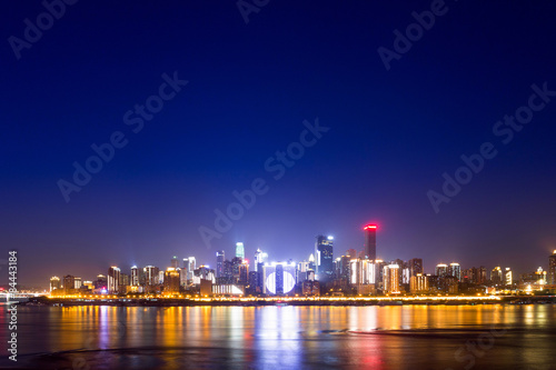 illuminated skyline of chongqing at riverbank