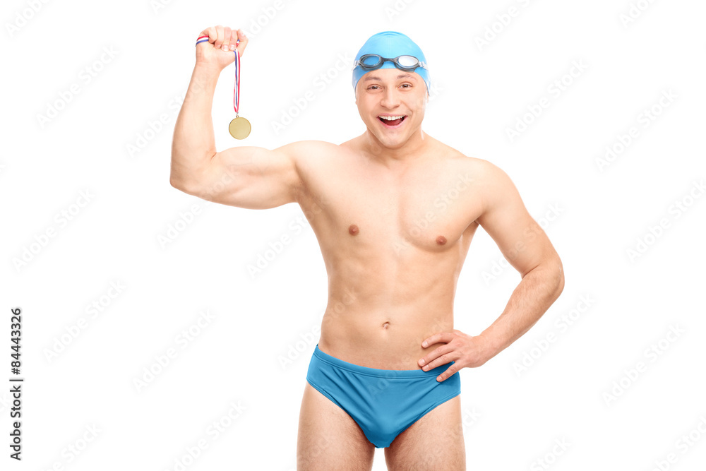 Cheerful young swimmer holding a medal