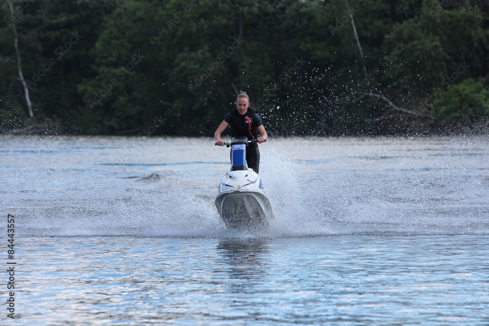Naklejka premium Action Photo young woman on jet ski. 