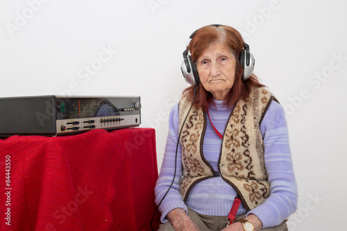 Elderly lady listening to the radio.