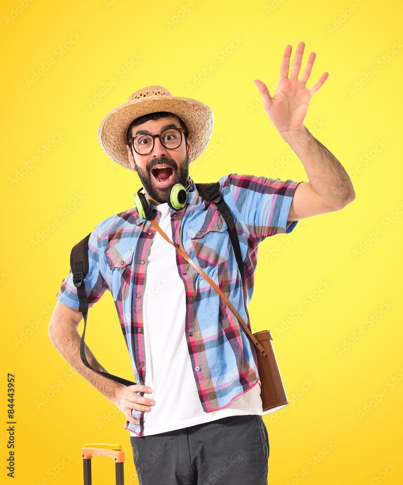 Tourist saluting over white background Tourist saluting over white background