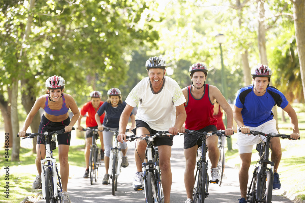 Obraz premium Group Of Cyclists On Cycle Ride Through Park