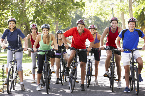 Group Of Cyclists On Cycle Ride Through Park