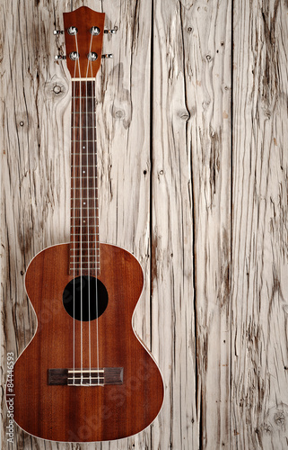 ukulele on aged wood background
