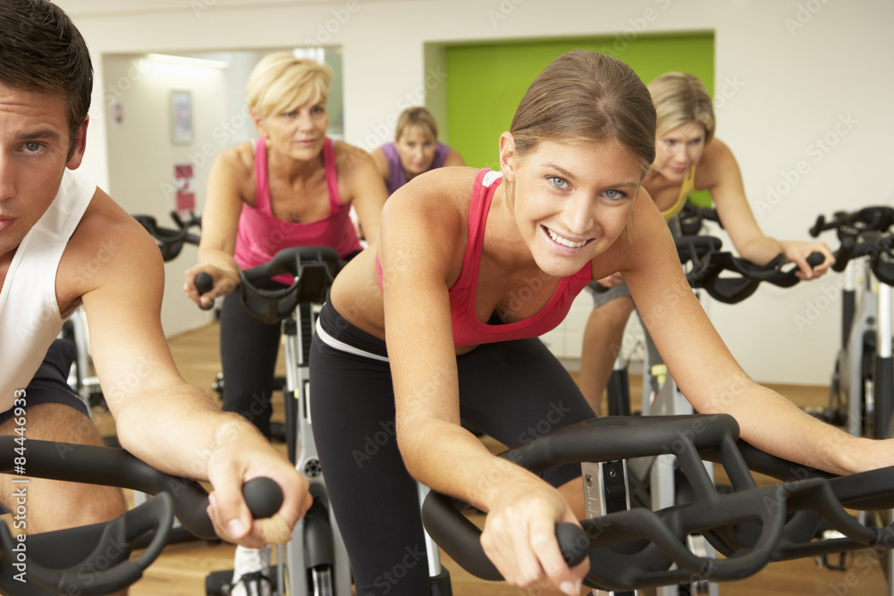 Group Taking Part In Spinning Class In Gym Group Taking Part In Spinning Class In Gym