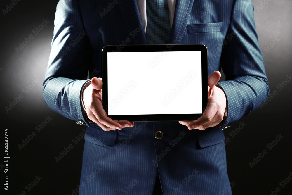 Man holding tablet on dark background Man holding tablet on dark background
