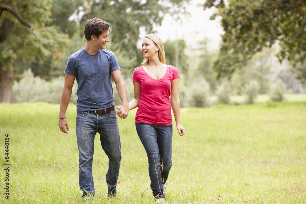 Romantic Young Couple Walking Through Countryside Romantic Young Couple Walking Through Countryside