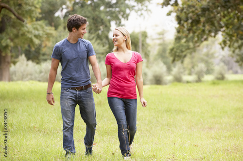 Romantic Young Couple Walking Through Countryside
