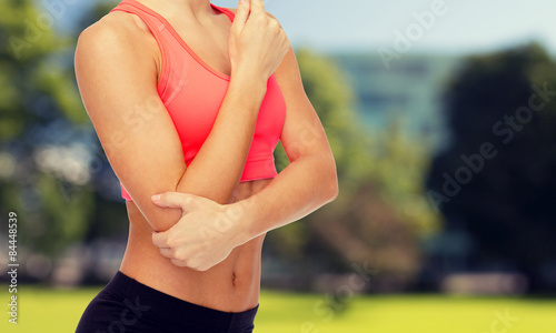 sporty woman with pain in elbow