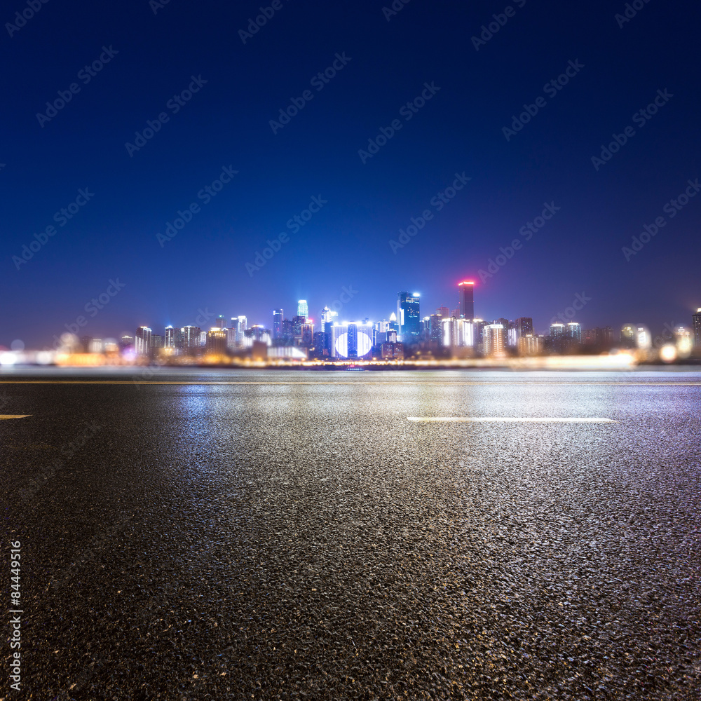 Fototapeta premium Empty floor and illuminated skyscraper