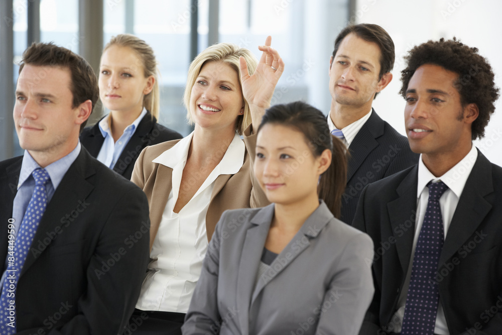 Businesswoman Asking Question During Presentation Businesswoman Asking Question During Presentation