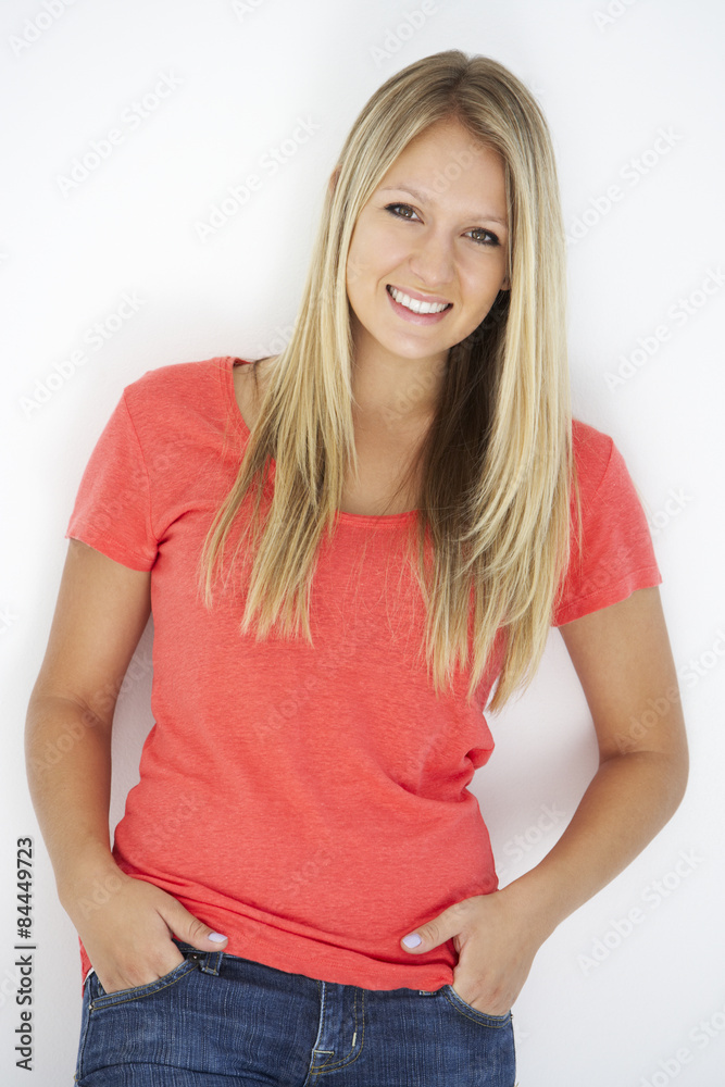 Studio Portrait Of Attractive Young Woman Leaning Against White Background Studio Portrait Of Attractive Young Woman Leaning Against White Background
