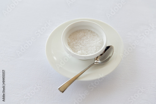 Fotografía sugar bowl and saucer with spoon on table