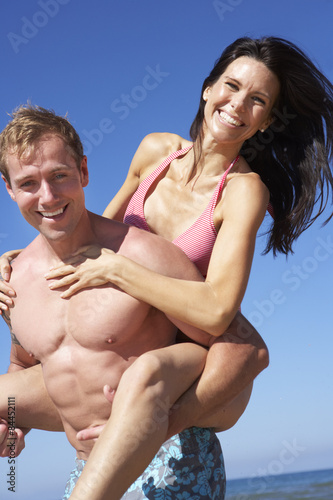 Couple Having Fun On Beach Holiday Together